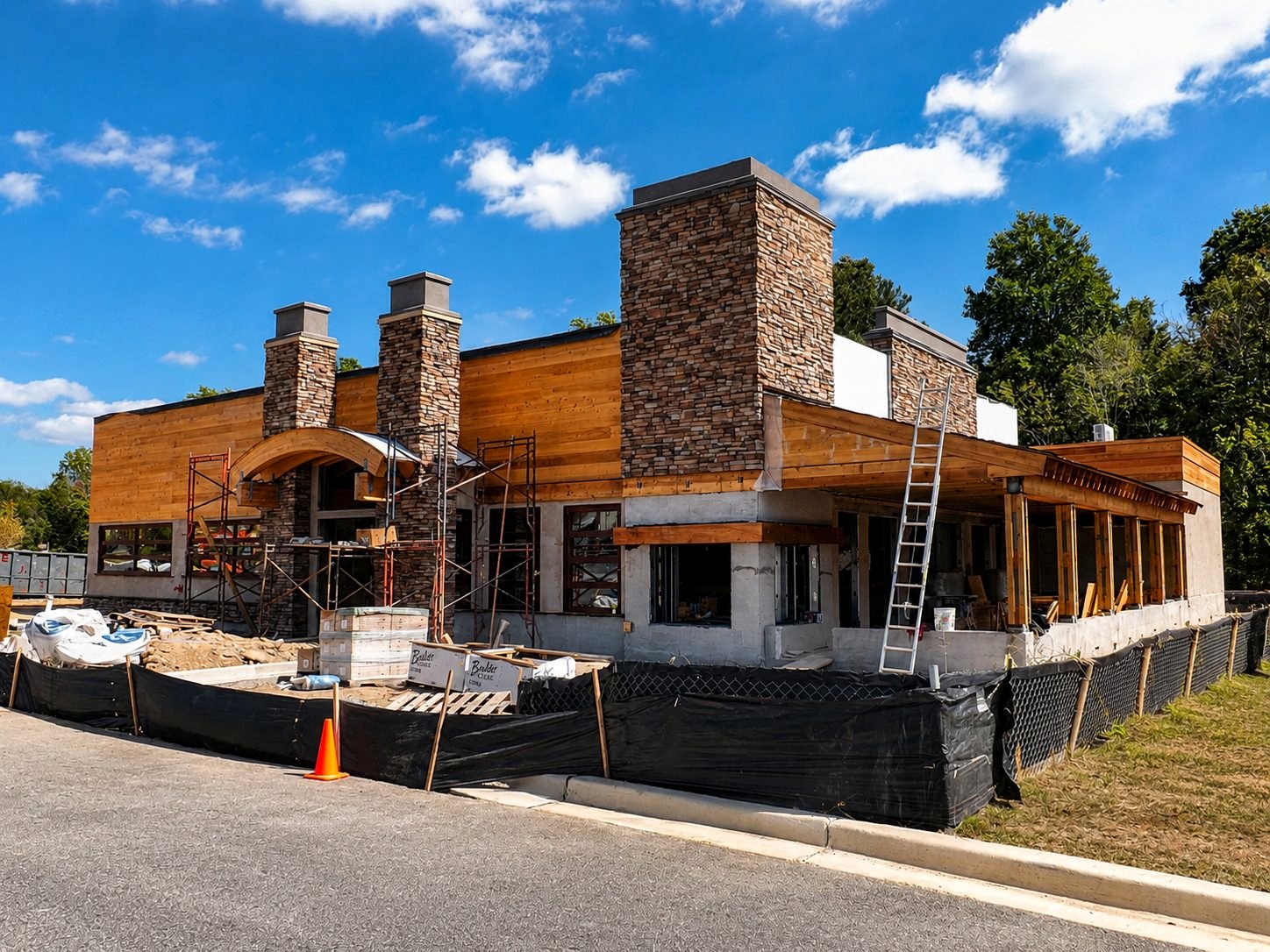 Restaurant under construction — timber and stone facade going up
